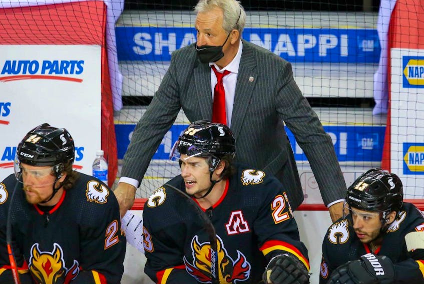 Calgary Flames head coach Darryl Sutter on the bench during a game against the Montreal Canadiens during NHL hockey in Calgary on Thursday March 11, 2021. 