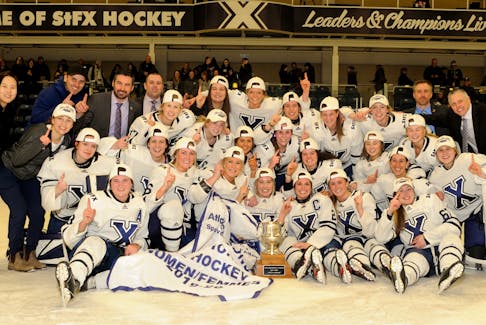 The St. F.X. X-Women celebrate winning the 2020 Atlantic University Sport (AUS) title March 5 on home ice at the Keating Centre. The White and Blue completed a final series sweep of the rival Saint Mary’s Huskies with a 5-3 come-from-behind victory. Bryan Kennedy 