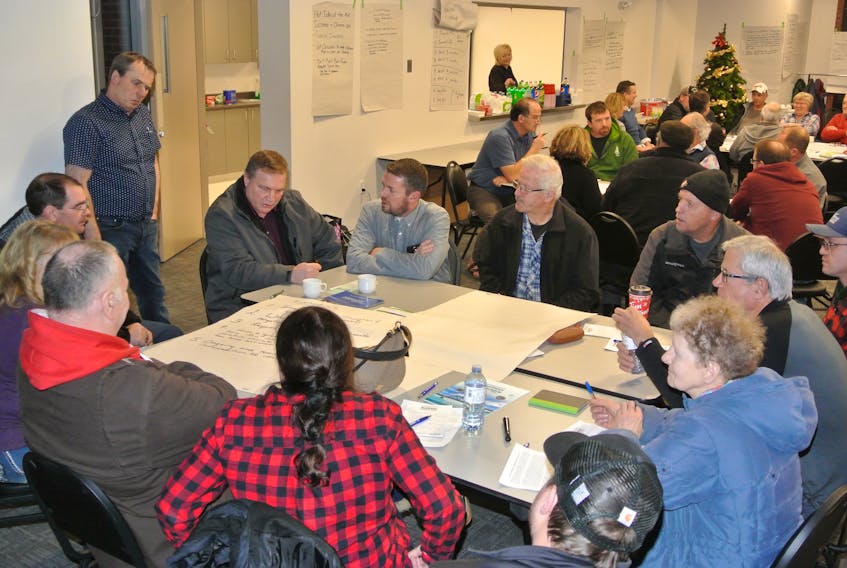 Ian Ripley, standing, of the Athol Forestry Co-operative listens into a group discussion during a recent Future of Forestry meeting at the Community Credit Union Business Innovation Centre in Amherst. The committee is continuing to meet and plan the future of the industry despite the closure of the Northern Pulp mill in Pictou County. Darrell Cole – Amherst News