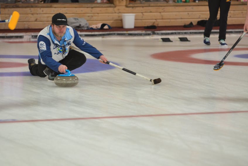 Skip Tyler Smith releases a shot during Saturday morning’s draw at the Pepsi provincial junior curling championships at the Crapaud Community Curling Club. The Smith rink is one win away from repeating as provincial junior men’s champions.