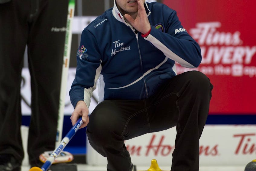 Ontario’s Scott McDonald, who has joined the Nova Scotia rink as skip at the Tim Hortons Brier in Calgary, yells instruction to his team during Draw 3 play Saturday. Nova Scotia defeated P.E.I. 11-4 to even its record at 1-1. - Michael Burns / Curling Canada