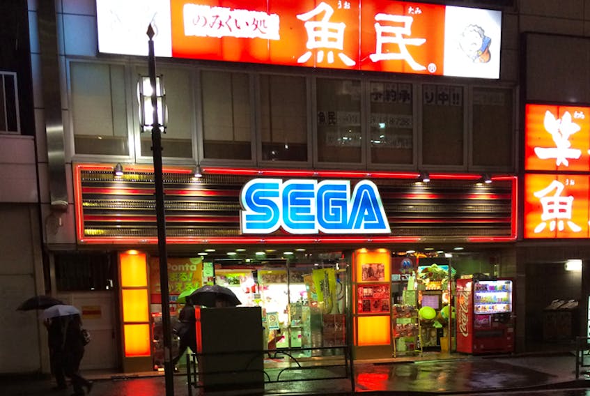 A Sega arcade is seen in Tokyo, Japan, in 2014. The interplay of urban retail lighting, poor weather and technology forms a core aesthetic in cyberpunk media.