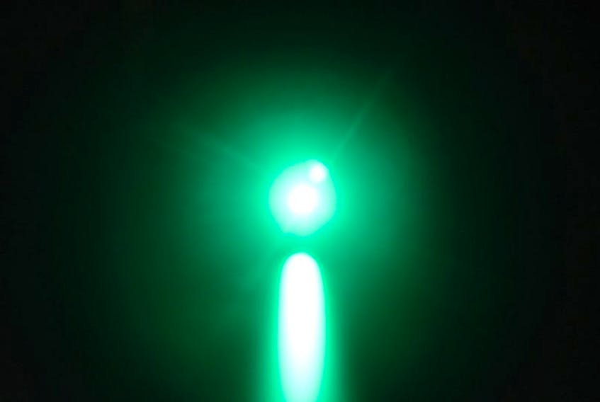Illustration of distant green laser aimed at target.