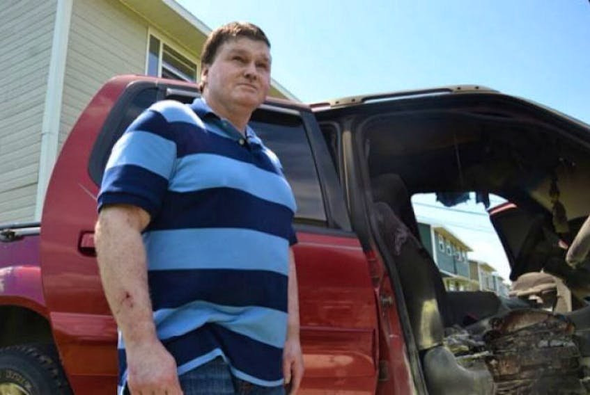 Dwayne Dalton stands beside his truck that was burned outside of his Sydney home on Tuesday morning. The fire invoked frightening memories of an incident four years ago that left him with burns to most of his body and very nearly cost him his life.