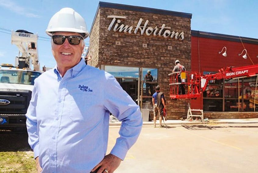 Danny Murphy poses outside his Tim Hortons coffee shop on Water Street in Summerside this week. Murphy says rumours that he is looking to sell any or all of his 20 Tim Hortons' operations on P.E.I. are false.