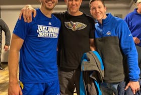 Nate Darling, left, poses with his father Jason and brother Josh after playing an NCAA game for the University of Delaware against Villanova University last season.