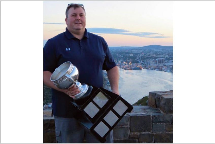 Darryl Seward has won league titles as video coach of the QMJHL’s Moncton Wildcats and AHL’s Lake Erie Monsters, as well as an Ivan Hlinka tourney gold medal with Canada’s under-18 team. Here, he is shown with the Calder Cup AHL championship trophy on Signal Hill last summer. Now that the 44-year-old Seward has been hired as video coach of the NHL’s Vancouver Canucks, he can been forgiven for hoping to someday strike the same pose with a Stanley Cup.