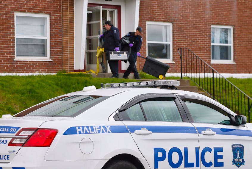 Members of the Halifax Regional Police forensic identification unit leave an apartment building at 32 Lakefront Road after investigating a suspicious fire Thursday morning. TIM KROCHAK