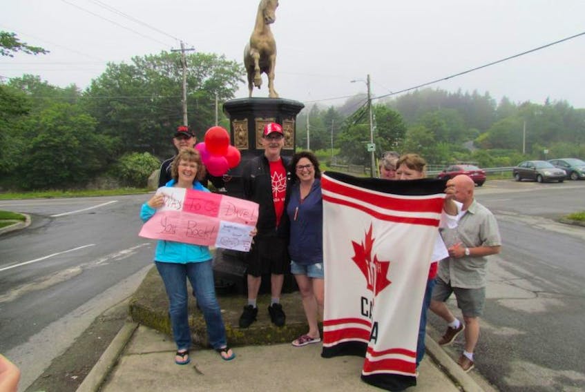 Yarmouth resident Dave Durkee (in hat and shorts, directly in front of horse fountain) and well-wishers on the day he finished his "virtual" walk across Canada on July 1.