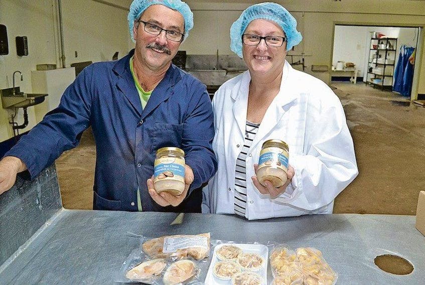 <p><span>David and Carla Annand, owners of Annand Clams, show some of the Atlantic bar clam products they are producing at their plant in Conway. The bottled bar clams are their number one seller, but they are banking on frozen bar clam meat, clams in the half-shell, breaded clams and bar clam tarts taking off once those products become known to consumers. Eric McCarthy/TC Media</span></p>