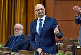 Justice Minister David Lametti rises to vote in favour of a motion on Bill C-7, regarding medical assistance in dying, in the House of Commons on Thursday, Dec. 10, 2020.