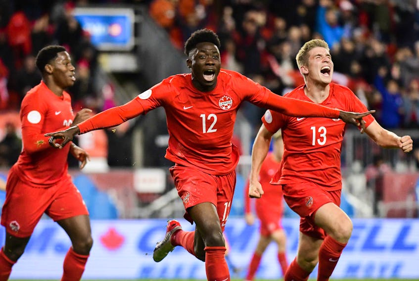 Team Canada’s Alphonso Davies, left, and Liam Fraser celebrate Davies’ goal against the United States in a CONCACAF Nations League match at BMO Field on Oct. 15, 2019. 