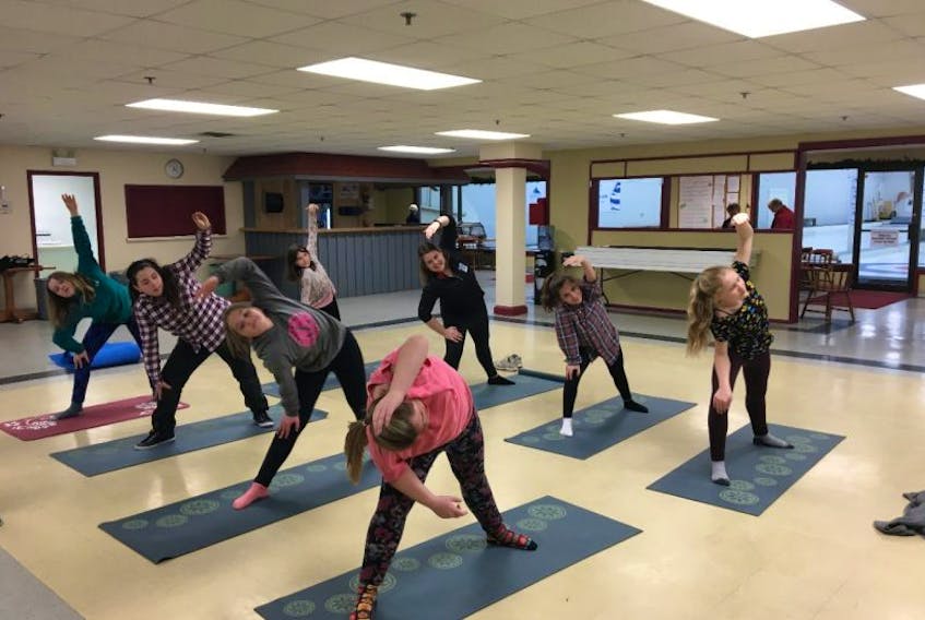 Students taking part in Girls Only Multi Sport try out their yoga skills Jan. 30.