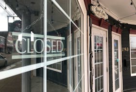 A closed sign as seen through the window of a downtown Sydney restaurant.  GREG MCNEIL/CAPE BRETON POST