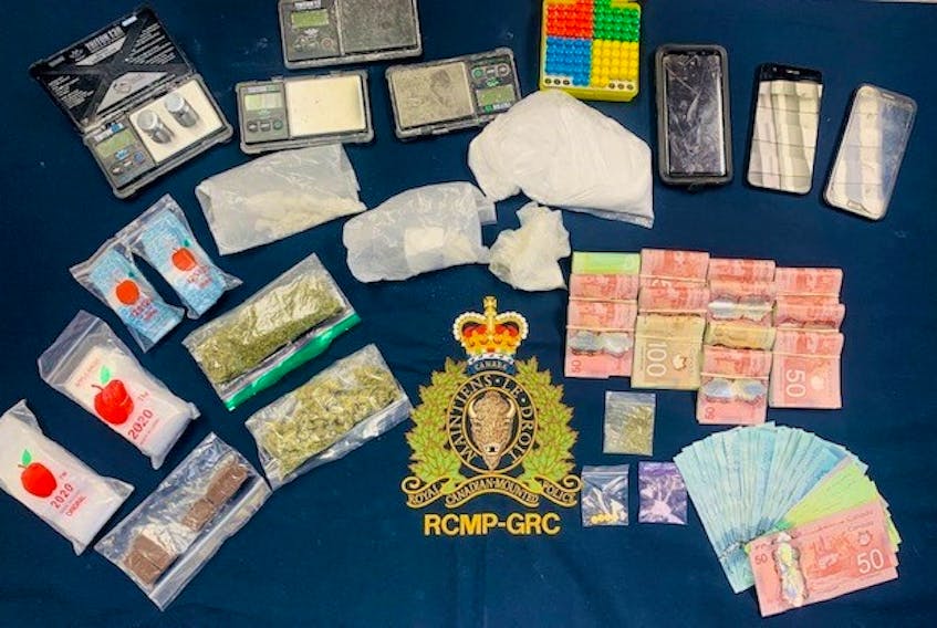Items seized by the RCMP during a search of a Deer Lake home on Tuesday include cocaine, illicit cannabis, prescription drugs and cash. RCMP photo