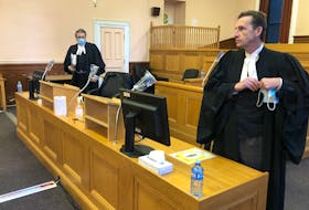 Prosecutor Mike Murray (foreground) and defence lawyer Mark Gruchy prepare to leave a courtroom at the province's Supreme Court in St. John's Thursday morning, after the sentencing hearing for a MUN student convicted of attempting to throw himself and his friend off a cliff at Signal Hill in a murder-suicide.