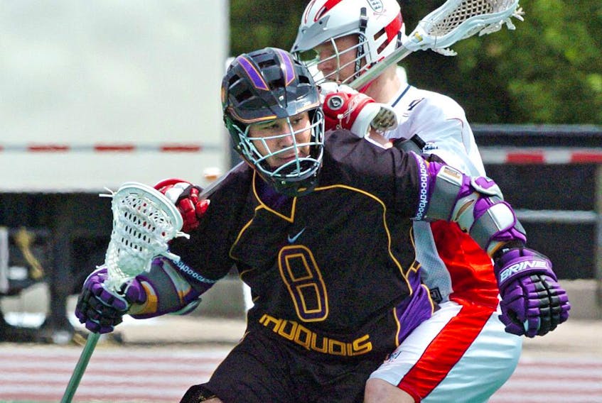 Delby Powless of the Iroquois Nationals eludes an England player during their opening game at the world lacrosse championships in London, Ont., in 2006.