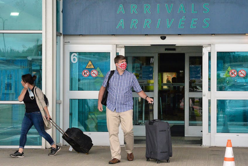 Passengers arrive at St. John's airport from Halifax on the first day of the Atlantic bubble.