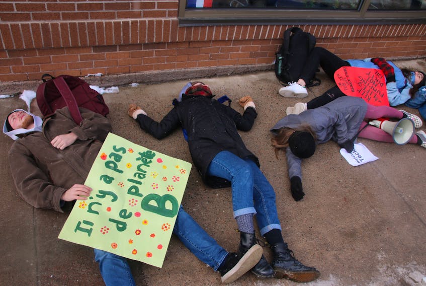 A few young people took part in a die-in on Inglis Place, in front of MP Lenore Zann’s office, on Feb. 14. They were trying to bring awareness to the urgent need to protect the environment. LYNN CURWIN/TRURO NEWS