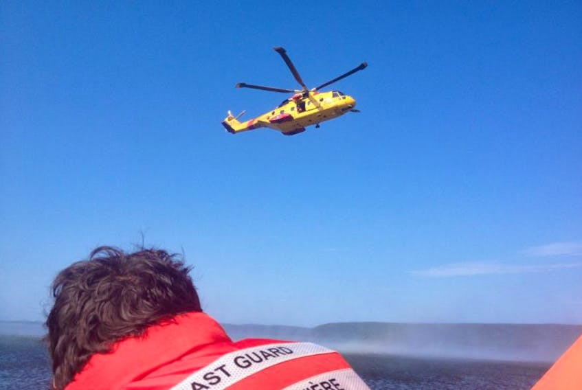 <p>A Cormorant helicopter from CFB Greenwood hovers over our life raft during a search and rescue exercise on the Annapolis Basin on Tuesday, Aug. 26.</p>