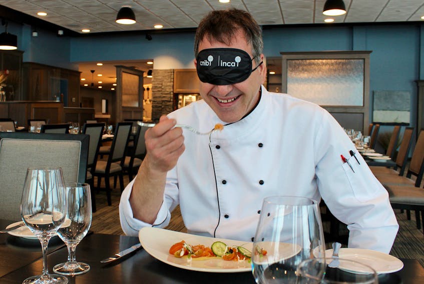 Chef Stephen Hunter samples one of his student's dishes blindfolded at the Holland College Culinary Institute recently. GRACE GORMLEY/THE GUARDIAN