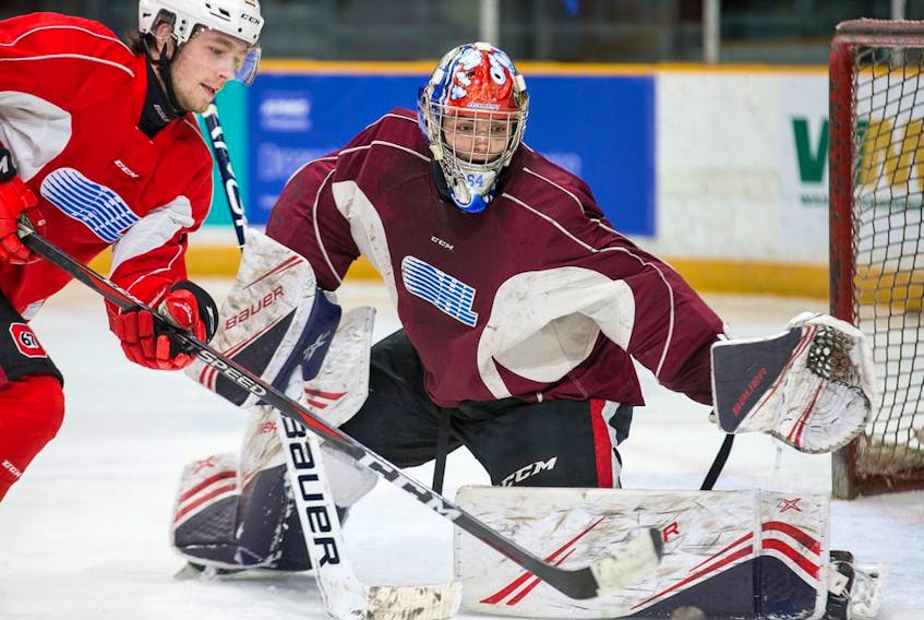 Ottawa 67's goalie Mike DiPietro battles against Quinn Yule in 2018.