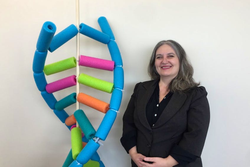 Memorial University geneticist Sevtap Savas and a model of the double helix, the original visualization of the structure of DNA created by Watson and Crick in 1953. PETER JACKSON PHOTO