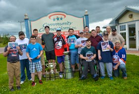 Noah Dobson poses with clients of Community Connections in Summerside. Dobson visited the non-profit organization that provides employment, residential and support services to adults with intellectual disabilities with the Memorial Cup and President Cup on Monday afternoon. Front row, from left: Evan Blood, Mitch MacNevin, Brad Cole, Kolton Doucette and Earl Shea. Back row: Ben Whyte, Robbie Halliday, Dobson, Cole Somers, Alex Blanchard, Shane Waite, Leo Kinch, Edison Murray, Jamie Gallant, Norman Pickering and Ryan Nicholson.