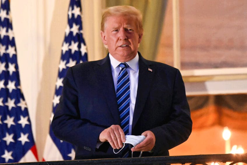 U.S. President Donald Trump stands on the Truman Balcony of the White House after returning from being hospitalized at Walter Reed Medical Center for COVID-19 treatment, October 5, 2020.