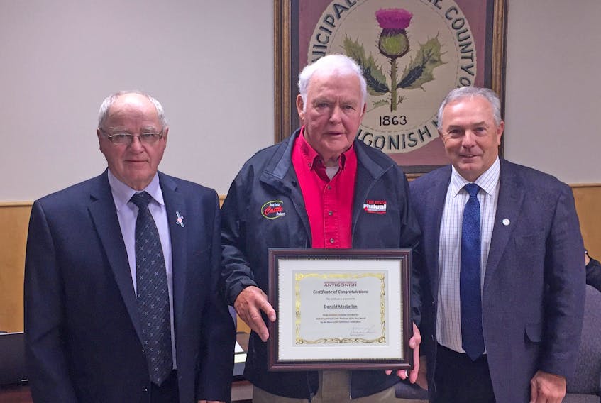 The Municipality of the County of Antigonish honoured Donald MacLellan (center) at its regular monthly meeting Oct. 15 with a certificate of congratulations. The award recognized the veteran farmer for his contributions to agriculture and the broader community. Earlier this year, MacLellan was named Kings Mutual Cattle Producer of the Year by the Nova Scotia Cattle Producers. Deputy Warden Hughie Stewart (left) and Warden Owen McCarron made the presentation to MacLellan on behalf of the municipality. Corey LeBlanc