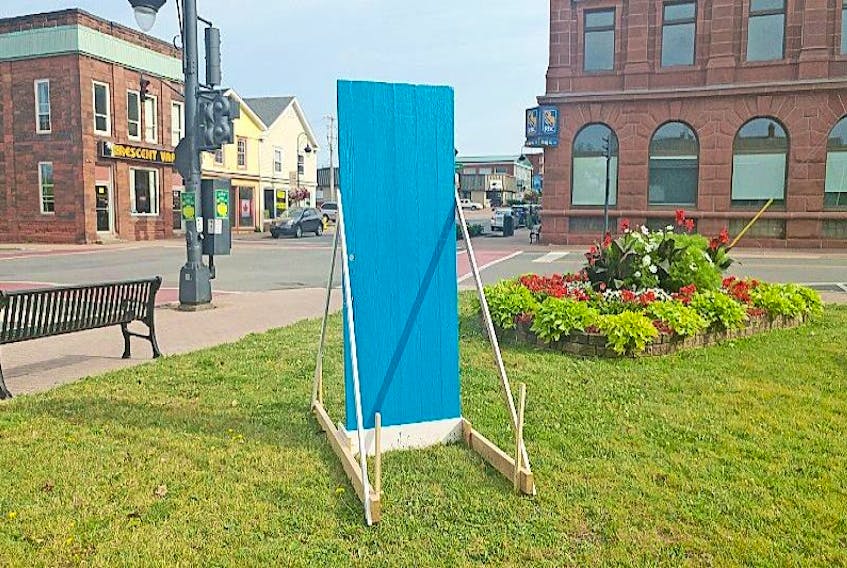 This blue door, which stands in the open lot across the street from town hall, is just one of many that have mysteriously appeared in towns across the region.