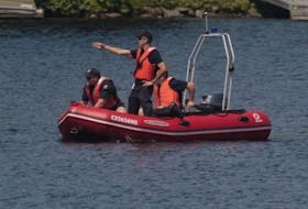 A Halifax Regional Police cruiser searching for a missing swimmer on Lake Banook Aug. 16. The man's body was located later in the day. 