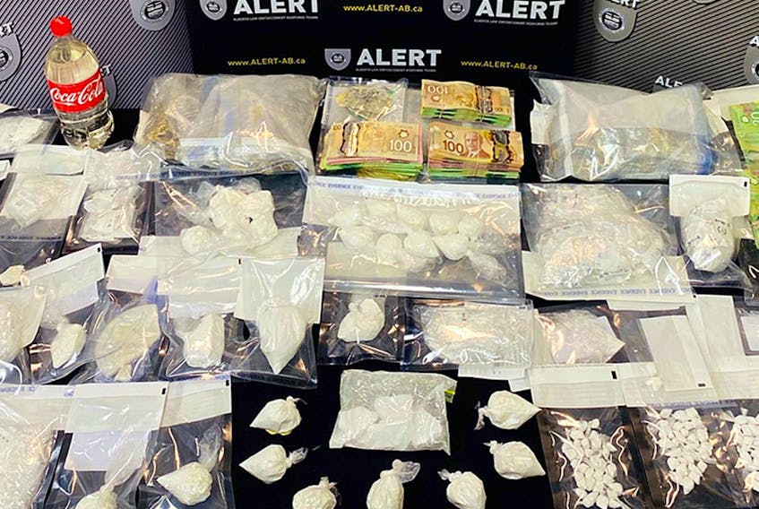 Photo of a table of drugs and cash seized in Project Incumbent, an ALERT investigation that dismantled a drug network in Grande Prairie, Alta. Supplied image/ALERT