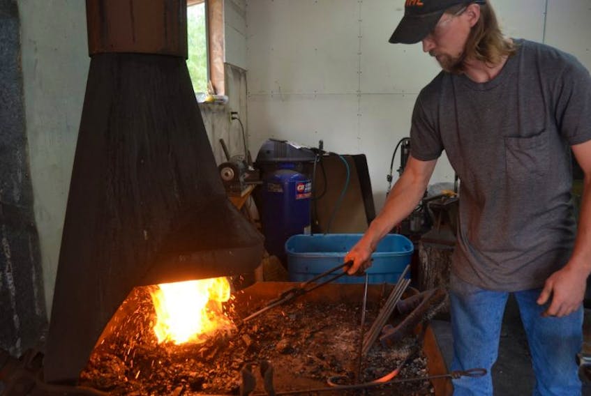 Jake Roscoe creates one of his ironworks pieces.