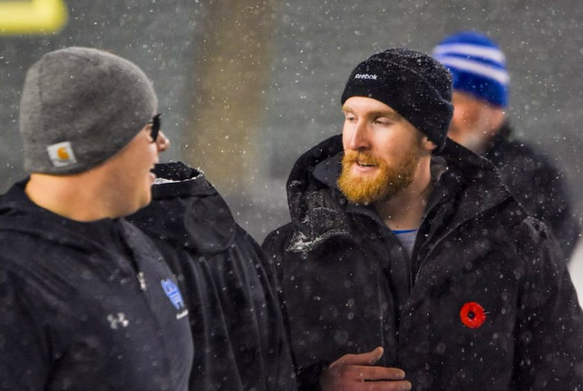 Tyler Greenslade, seen here on the sideline with his Harry Ainlay Titans at Commonwealth Stadium during the Metro city championships on Nov. 8, 2019, has been named the 2019 Norm Kimball head coach of the year for Football Alberta. 
