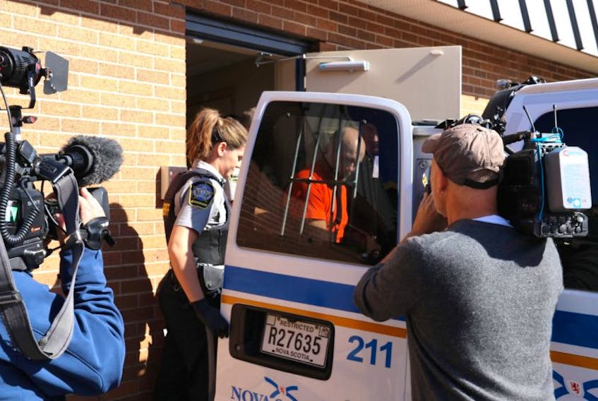 Ernie Duggan of Bayhead is seen being loaded into a sheriff's vehicle to transport him back to his cell in Dartmouth following a court appearance in Truro Tuesday morning/