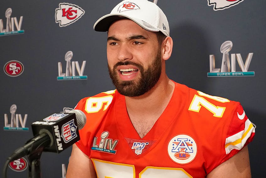 Laurent Duvernay-Tardif of the Kansas City Chiefs raises the Vince Lombardi Trophy after defeating the San Francisco 49ers 31-20 in Super Bowl LIV at Hard Rock Stadium on Feb. 2, 2020 in Miami, Fla. 