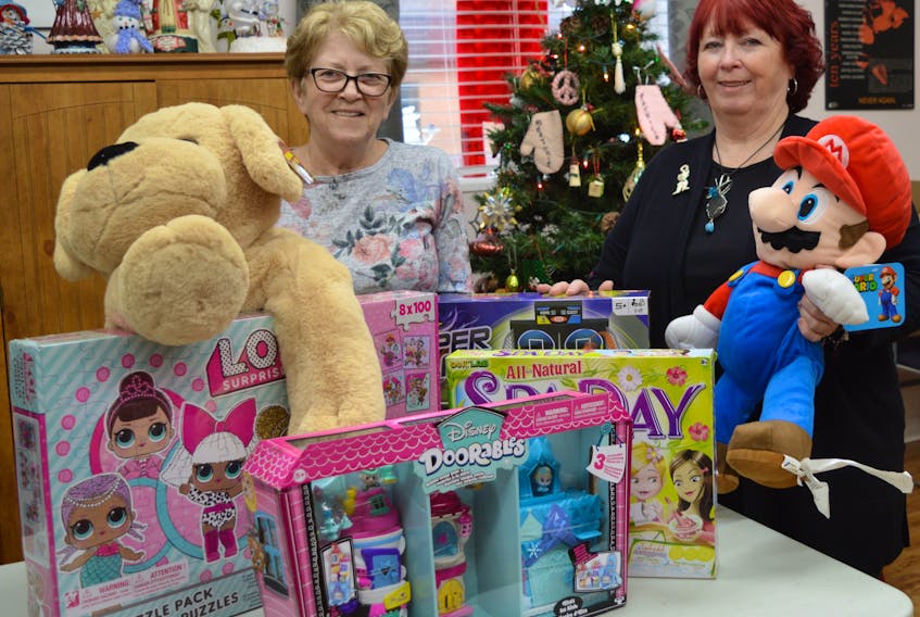Diane Parlee, left, and Wanda Earhart were preparing for Every Woman's Centre's annual adopt-a-family program in this November 2019 file photo. Each year, the Sydney organization helps about 600 families in need have a brighter holiday season. Nancy King • Cape Breton Post