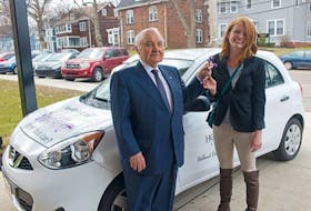 <span>Lou MacEachern presents the keys to a new car to Emily VanToever, a student in the Construction Electrical Technology program at Holland Colege. She earned the car by her achievements in the course. </span>