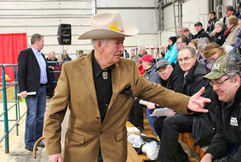 <span class="Normal"><span class="COLOURKicker">Bid taker Bob Connolly hunts down the next bid for the grand champion steer at the 65th annual Easter Beef Show and Sale in Charlottetown on Friday. </span></span>