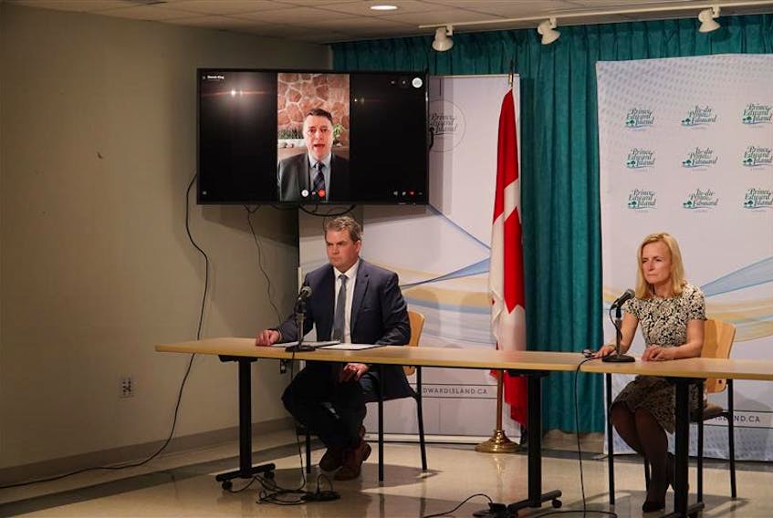 Public Safety Minister Bloyce Thompson, left, and chief public safety officer Dr. Heather Morrison give an update on the coronavirus (COVID-19) on March 24, 2020 as Premier Dennis King joins by video conference from his home where he is in self-isolation.