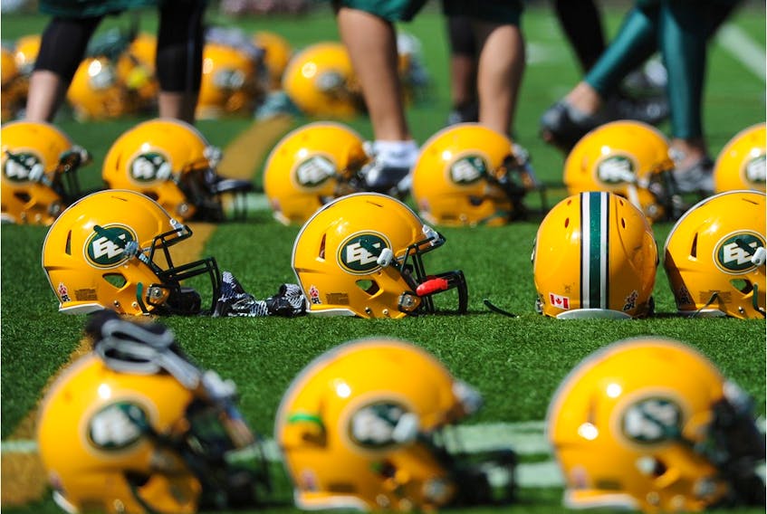 Edmonton Eskimos helmets line the field in this file photo from 2014 training camp.