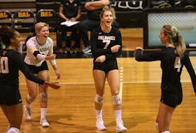 Dalhousie Tigers' Julie Moore (7), reacts to her kill with teammates Courtney Baker (10), Catherine Callaghan (white jersey) and Victoria Turcot  (4) during a match last season.  Moore, Callaghan and Turcot are a key members  of the Tigers' leadership group. 
TIM KROCHAK/ The Chronicle Herald