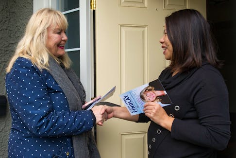 South Surrey-White Rock Conservative candidate Kerry-Lynne Findlay shakes hands with Eva Bai during a door knocking session in the Morgan Creek area of the riding Tuesday.