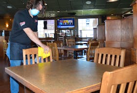 Ryan Wall is shown ensuring everything is clean at Ziggy’s Pub and Grill on Friday. Survey data indicates that 24 per cent of Cape Breton employers plan to hire for the upcoming quarter, while seven per cent anticipate cutbacks. GREG MCNEIL/CAPE BRETON POST