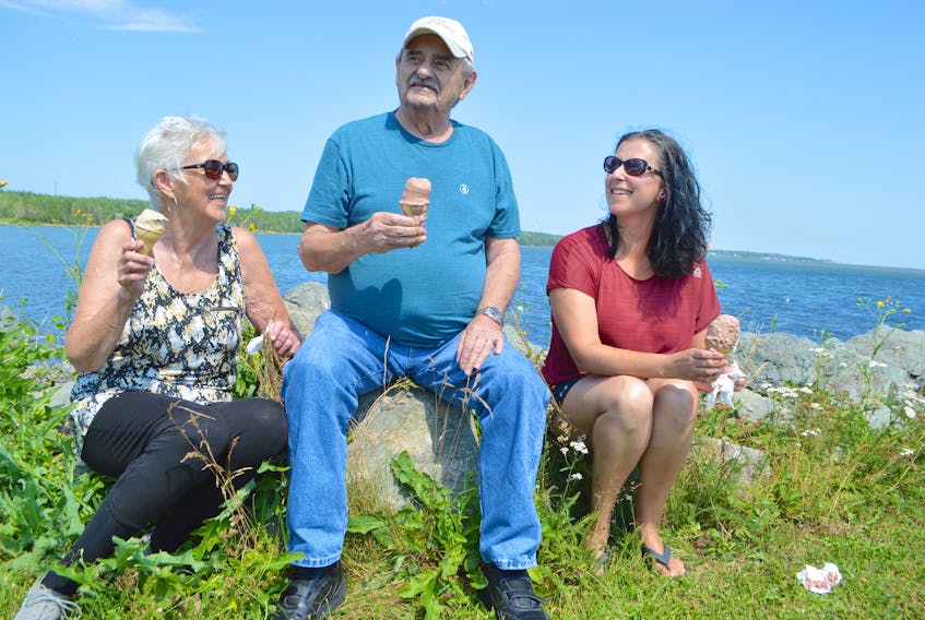 Maurina Canova, left, husband Sheldon and daughter Anna, celebrate the great Cape Breton summer weather with ice cream at the Bayside Drive-In in River Ryan, Monday. The family, which was at Dominion Beach earlier in the day, say they often go out for drives around the area together. Sharon Montgomery-Dupe • Cape Breton Post