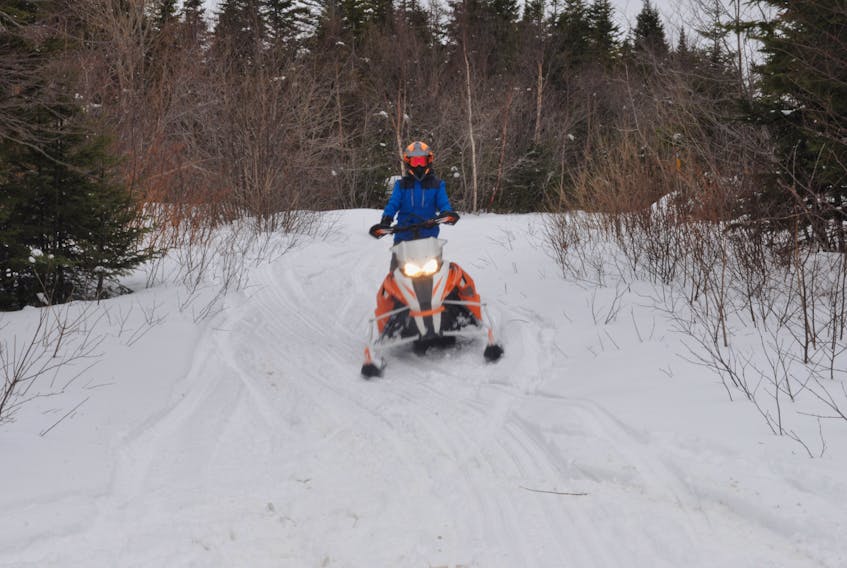 On some fresh snow from a Feb.19 storm, Noah Blanchard of Cold Brook was enjoying a snowmobile ride on a trail adjacent to Igloo Road in Stephenville. Snowmobile enthusiasts can get around quite well this winter with lots of snow. FRANK GALE/ THE WESTERN STAR