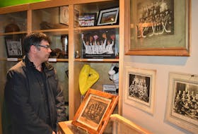 Well known local curler Craig Burgess is the chair of the Truro Sports Heritage Society which runs the Truro Sports Hall of Fame, located in the Marigold Cultural Centre. Here, he checks out a couple of his favorite displays; ones dedicated to Truro’s rich history in curling.