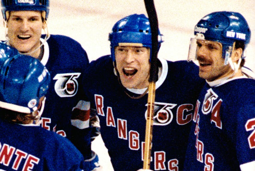 New York Rangers Mark Messier celebrates scoring the winning goal against the Edmonton Oilers at the Edmonton Coliseum in this file photo from Jan. 23, 1992.
