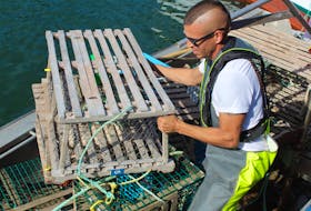Craig Doucette loading lobster traps onto his boat in this October 2020 file photo. CAPE BRETON POST FILE

